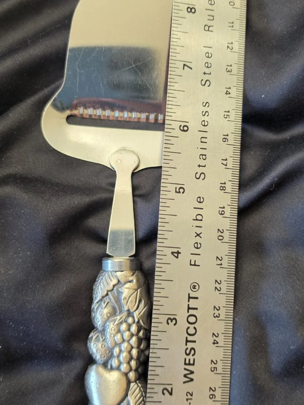 Stainless cheese slicer with fruit/leaf covered nicely weighted handle-kitchen